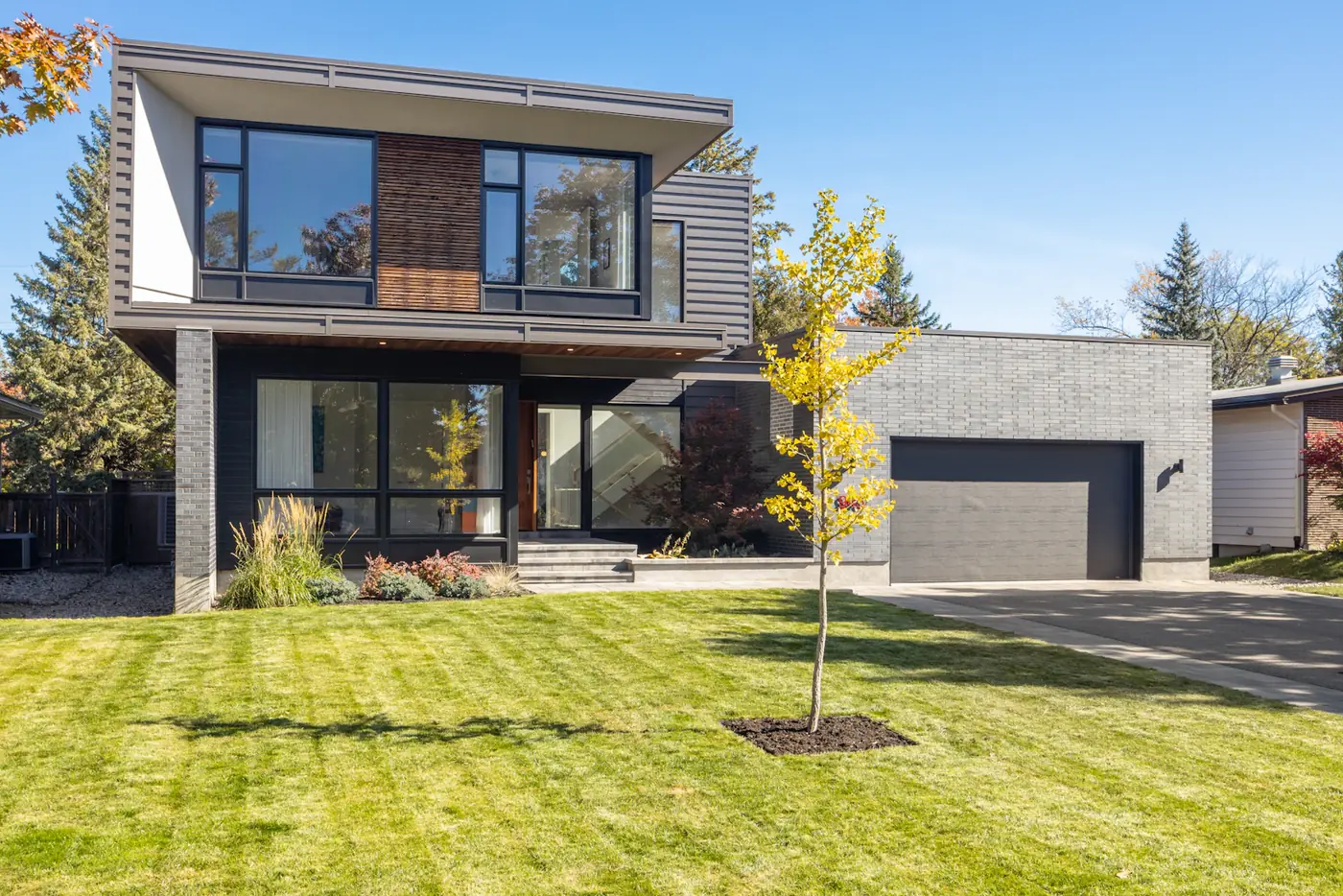 A modern two-story home with a lawn